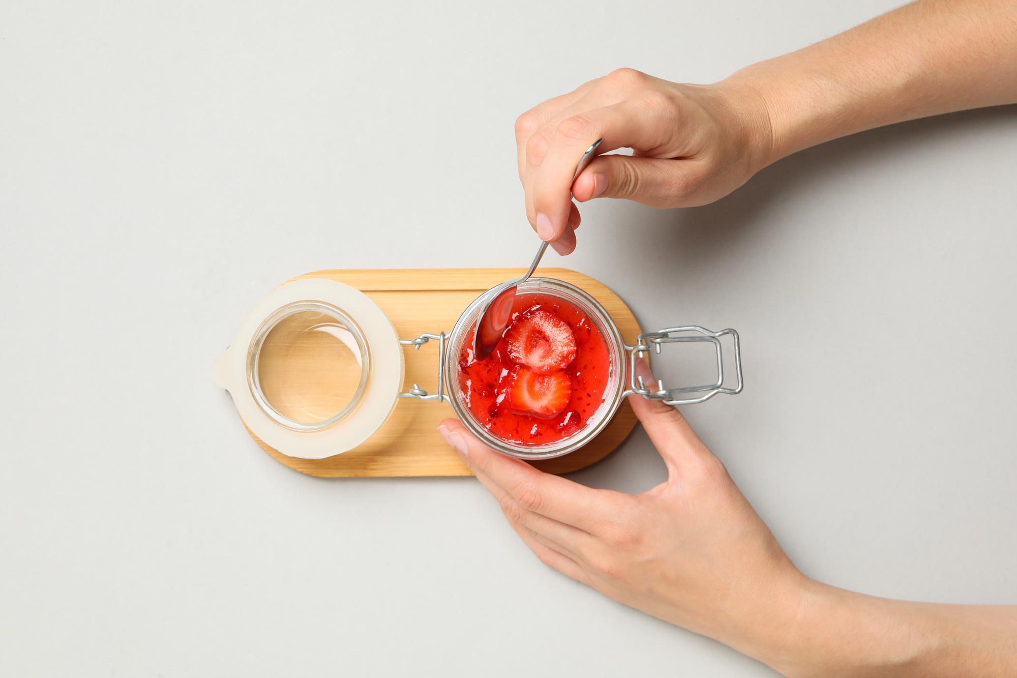Hands preparing a signature sauce in a small studio kitchen