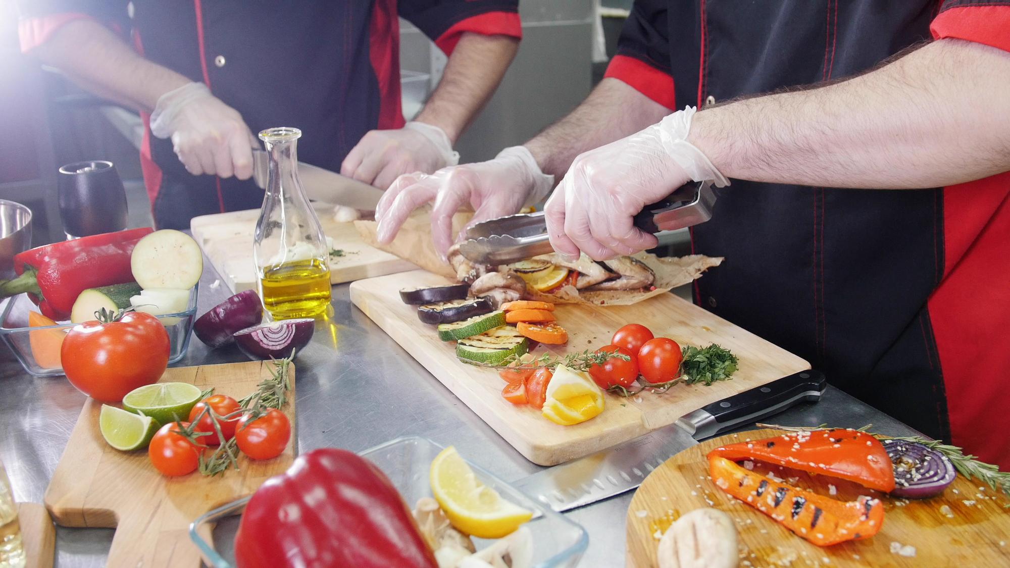 Chef demonstrating slicing technique to students